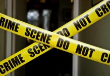 Toddler Killed by Mom Because He Was “The Anti-Christ” Yellow crime scene tape crossing a doorway