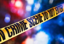 St. Paul Police Chief Sues Mayor yellow crime scene tape with blurred police lights