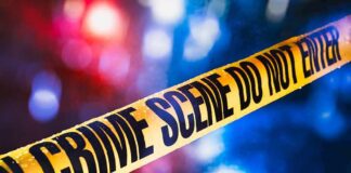 St. Paul Police Chief Sues Mayor yellow crime scene tape with blurred police lights
