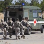 Iran Escalates: Two U.S. Soldiers Killed Soldiers running towards a medical vehicle during a military operation
