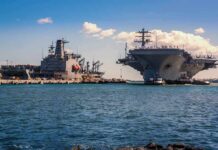 China’s Drone Swarms Challenge America’s Warship Aircraft carrier and support ships docked at a naval harbor