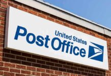Post Office sign on a brick building