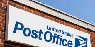 Post Office sign on a brick building