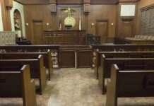 Supreme Court Blocks Missouri Map Again Interior view of an empty courtroom with wooden benches and a judges bench