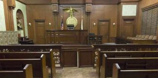 Supreme Court Blocks Missouri Map Again Interior view of an empty courtroom with wooden benches and a judges bench
