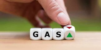 Gas Prices Top $4 as Trump Defends Costs Hand flipping dice showing gas with up and down arrows