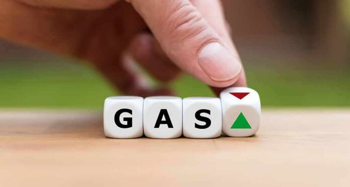 shutterstock_1263207622 Hand flipping dice showing gas with up and down arrows