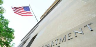 U.S. Forensics Firm Under Investigation Department of Justice building with American flag