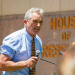The Confirmation Vote That Came Back to Haunt Robert F. Kennedy Jr. speaking into a microphone outdoors