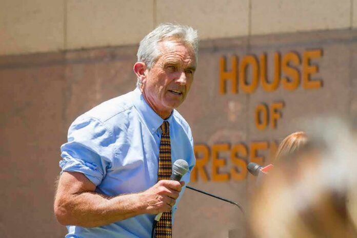 shutterstock_1401970814 Robert F. Kennedy Jr. speaking into a microphone outdoors
