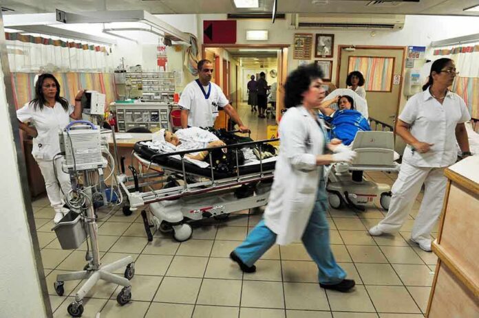 Medical staff attending to patients in a busy hospital emergency room