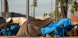 Street tents covered with tarps along a sidewalk