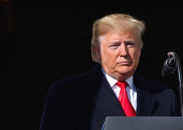 shutterstock_1551196562-1 Donald Trump at a podium with a microphone