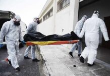 Four Children Killed in Planned Murder-Suicide medical team in hazmat suits carrying a body on a stretcher