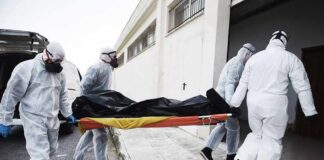 Four Children Killed in Planned Murder-Suicide medical team in hazmat suits carrying a body on a stretcher