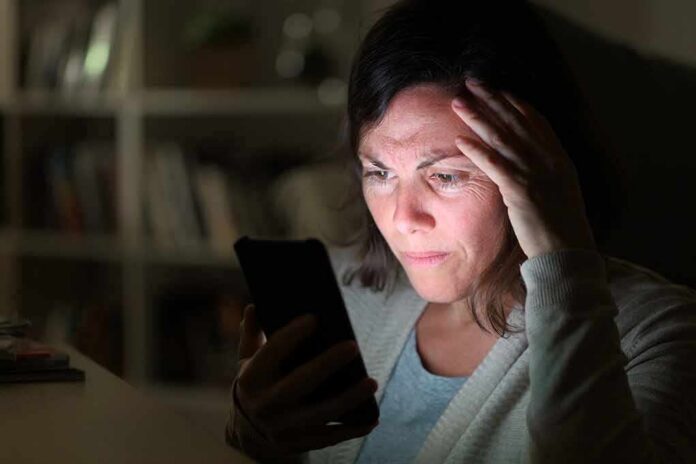 shutterstock_1733624393 Woman looking at smartphone with worried expression