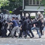 No Internet, Mass Arrests, and Deadly Clashes Protesters clash with riot police holding shields
