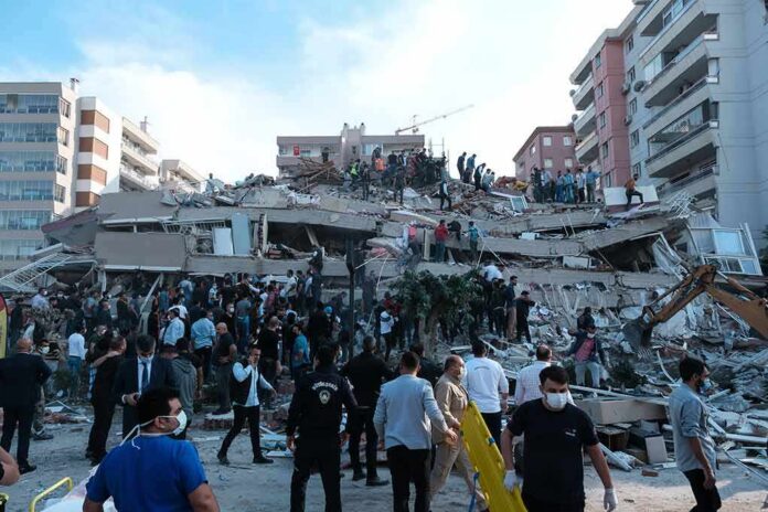 shutterstock_1845063010-1 Rescue workers and civilians on collapsed building after earthquake