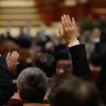 DNC Panel Advances “Abolish ICE” Resolution Raised hands in a formal meeting or vote