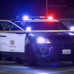 K-9 Ends 40-Minute Police Standoff Police SUV with flashing lights at night behind yellow tape