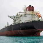 Trump Says U.S. Will Claim Strait of Hormuz Large oil tanker anchored in calm sea