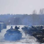 tanks lined up in a snowy motor pool