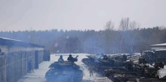 tanks lined up in a snowy motor pool