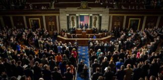Legislative chamber audience stands and applauds