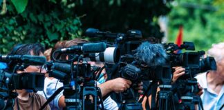 Memorial Post Sparks Misattributed Quote Backlash TV news cameras crowding together at an outdoor event
