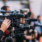 FBI Chief’s SHOCKING Pearl Harbor Dive REVEALED Video cameras on tripods at a media event