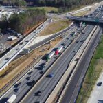 Aerial view of multi-lane highway interchange with overpass and traffic