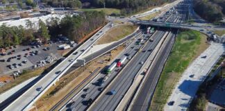 Aerial view of multi-lane highway interchange with overpass and traffic