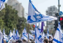 Israeli flags waved at a street demonstration