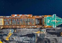Cargo ship docked at port seen from above