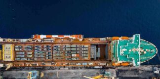 Cargo ship docked at port seen from above