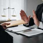 Two Shady Defense Contractors BUSTED in Massive Bribery Scheme! Businessman refusing an envelope at a desk