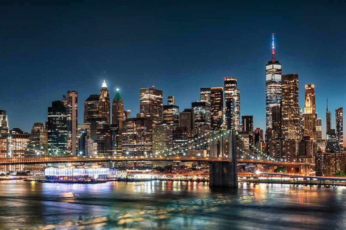 New York City skyline at night with Brooklyn Bridge