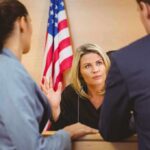 Judge speaking with two attorneys at the bench in a courtroom
