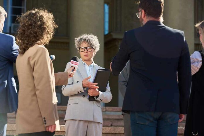 shutterstock_2690323305 Spokesperson addresses reporters on courthouse steps