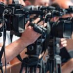WNBA Column Sparks Backlash Over Emmett Till Comparison television cameras on tripods at a media event