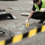 South Africa Tavern Shooting Leaves 18 Dead Forensic investigator marking evidence at crash scene