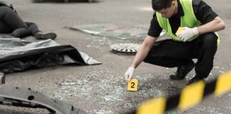 South Africa Tavern Shooting Leaves 18 Dead Forensic investigator marking evidence at crash scene
