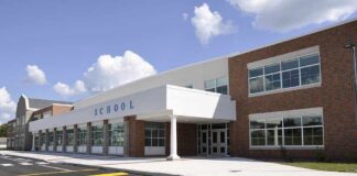 Tax-Exempt Status at Risk for Schools That Discriminate by Race Modern school building with large windows and a clear sky