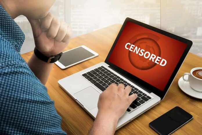 person using laptop with red warning screen at a cafe table