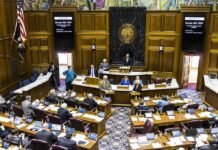 Legislative chamber with lawmakers debating a bill