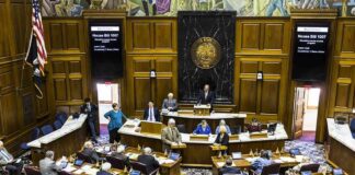 Legislative chamber with lawmakers debating a bill