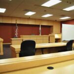 Alleged MS-13: Immigration Arrest in San Diego Interior view of an empty courtroom with wooden furniture and American flags