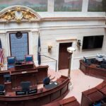 Legislative chamber interior with dais and desks