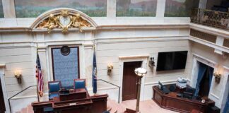 Legislative chamber interior with dais and desks