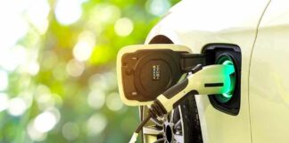 Electric car charging port with plugged-in cable